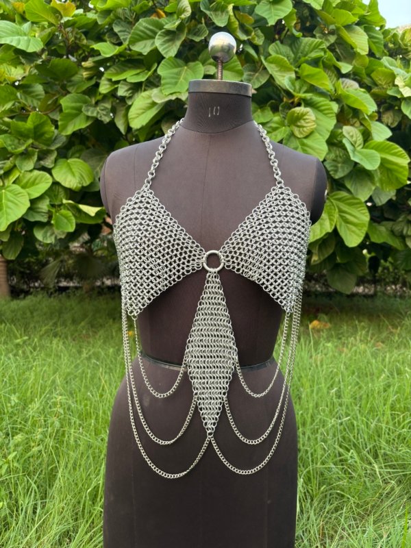 andmade chainmail halter top with draped chains, festival or cosplay armor top on dress form.