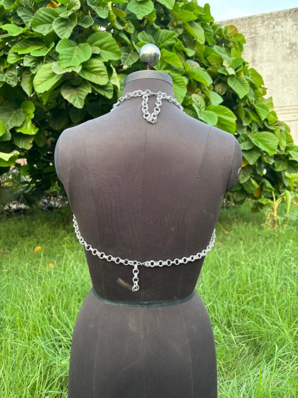 Handmade chainmail halter top with draped chains, festival or cosplay armor top on dress form.