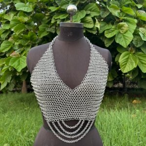 Chainmail halter top for women displayed on a dress form, handmade metal fashion armor top with draped chains.